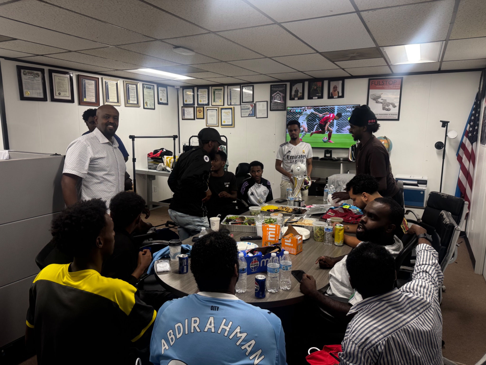 Tournament organizers and players gathered around a trophy