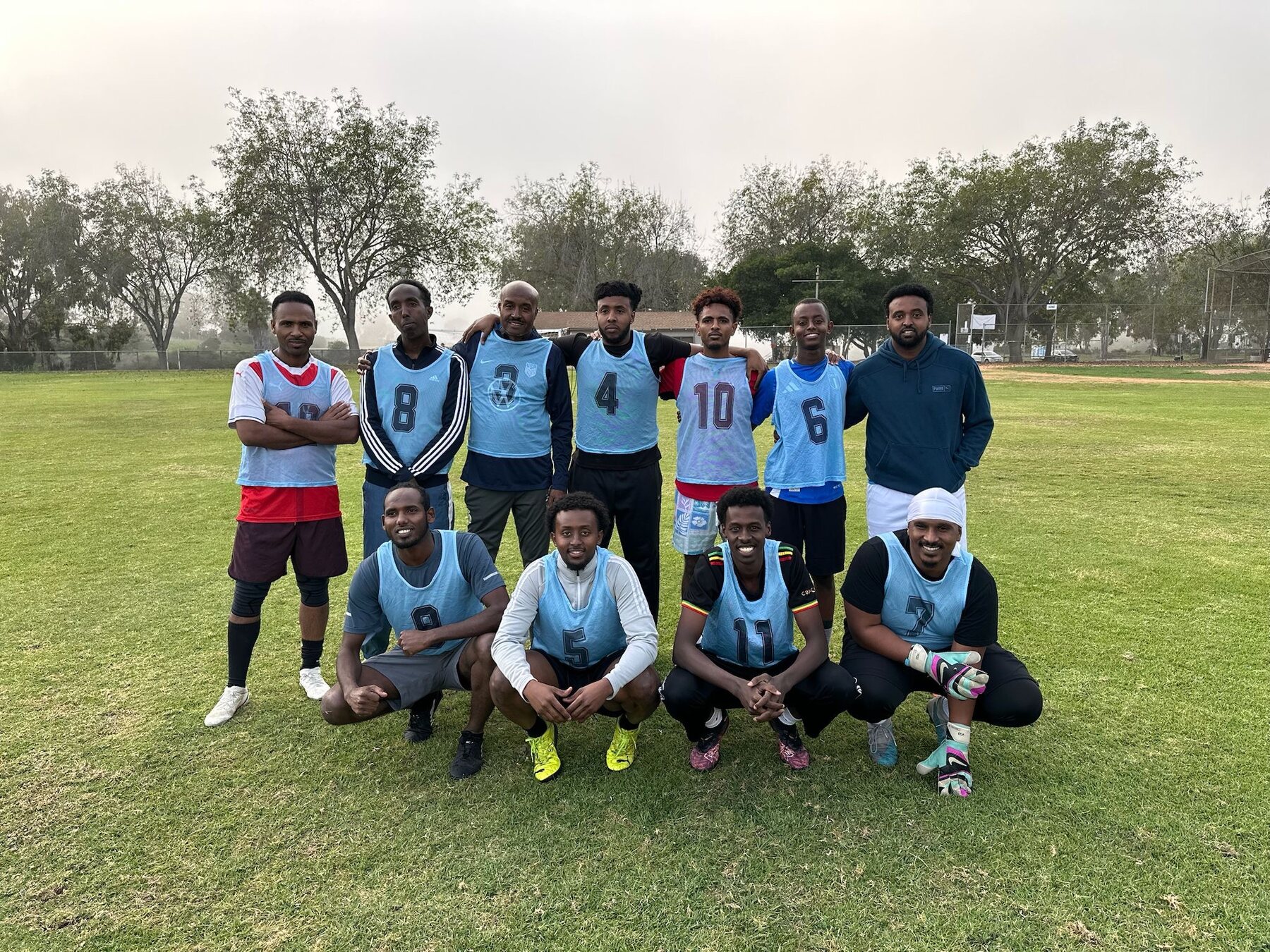 Blue team gathered on a community soccer field