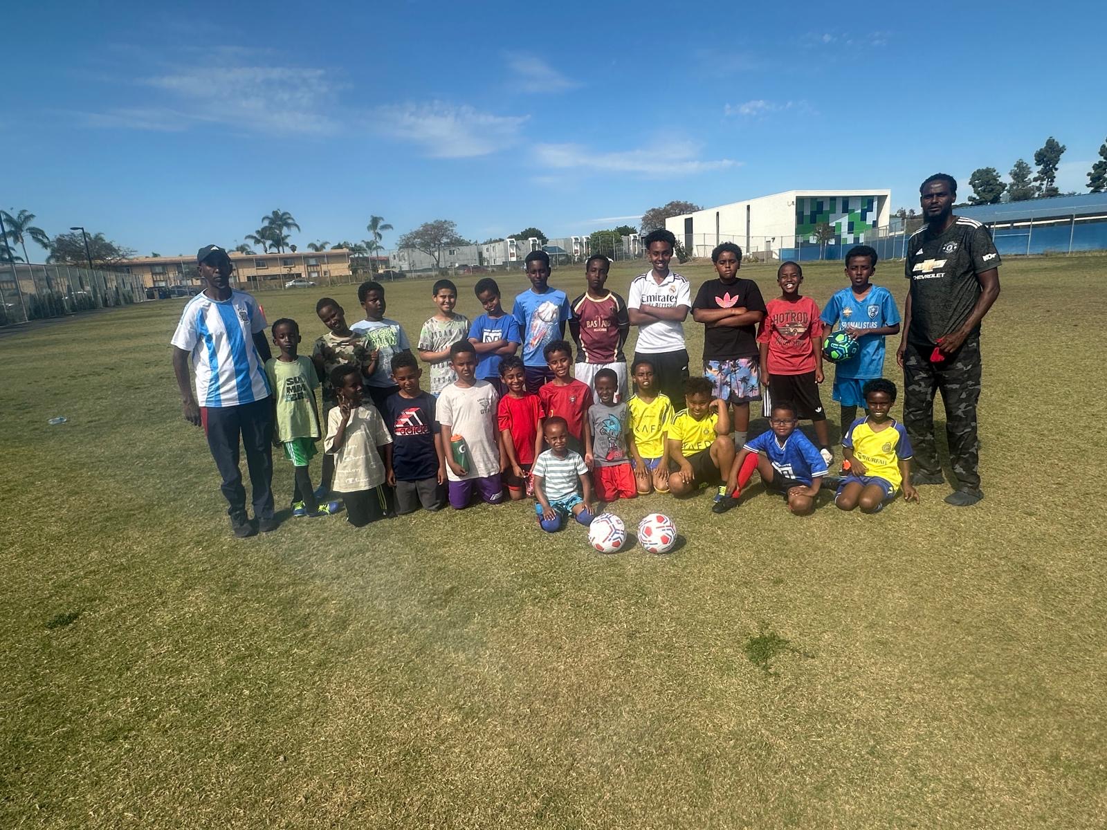 Youth soccer participants with two coaches