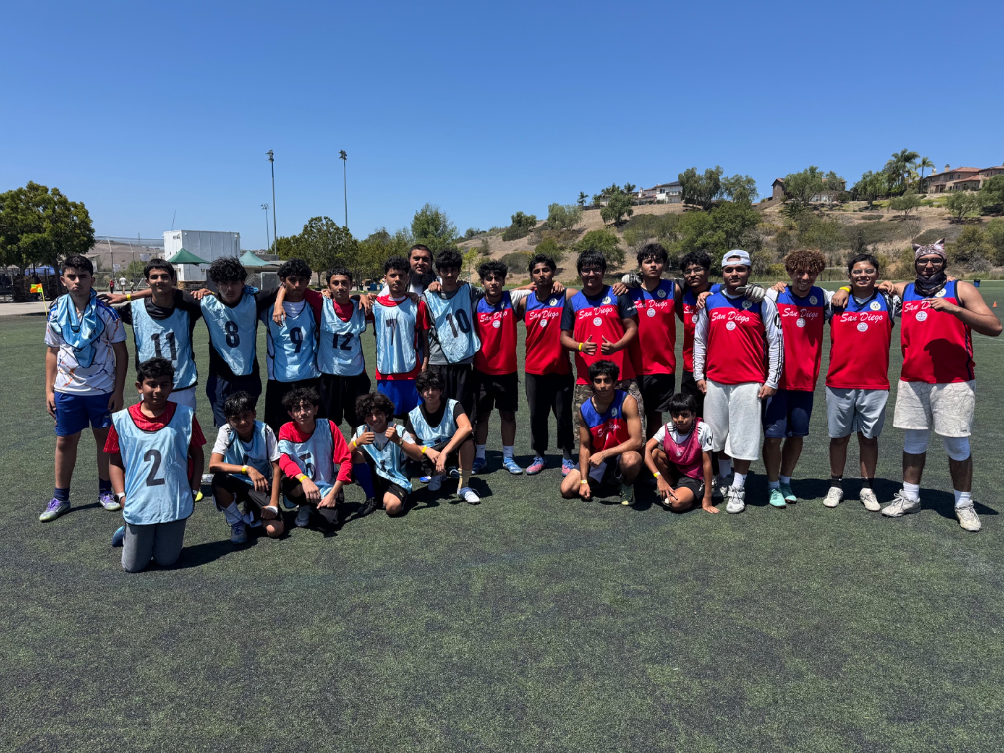 Young players from two soccer teams gathered together after a match
